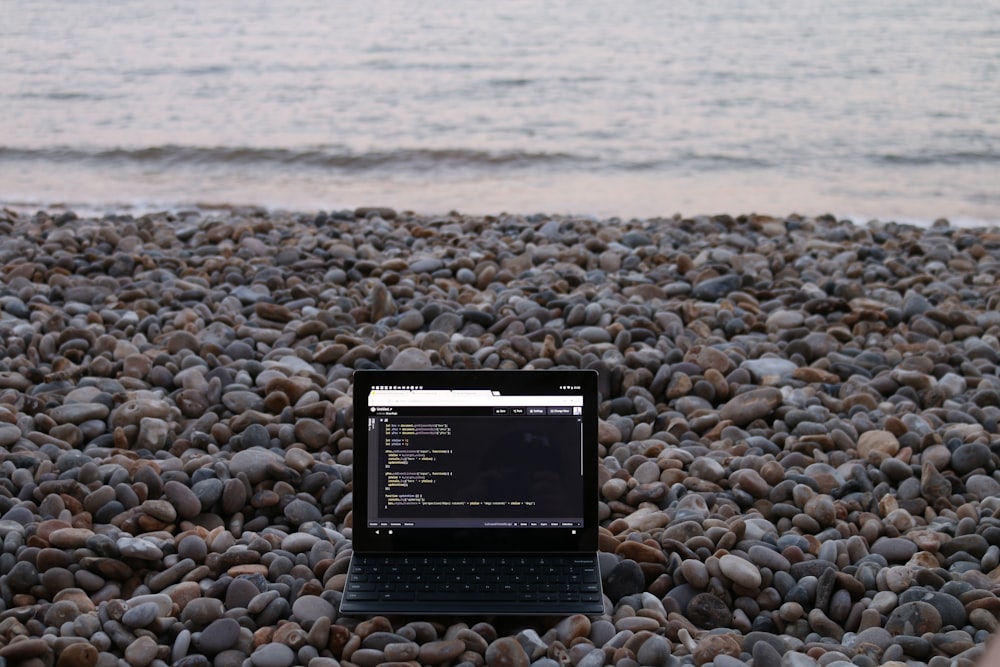 a tablet on a rocky beach