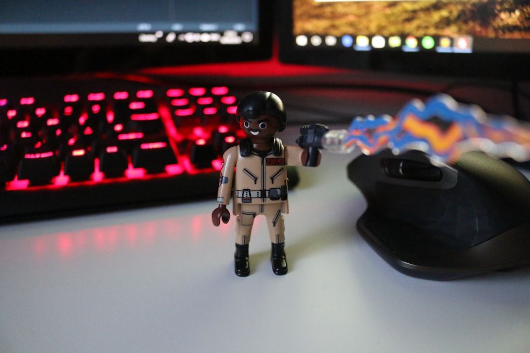 a toy figurine on a desk, Winston helping me fight bugs/ghosts.