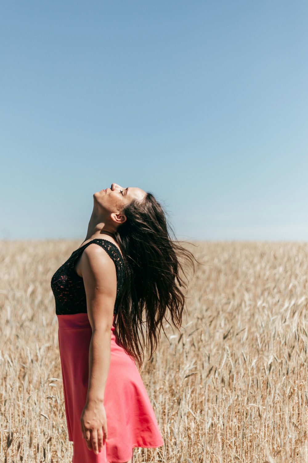 a person in a red dress in a field