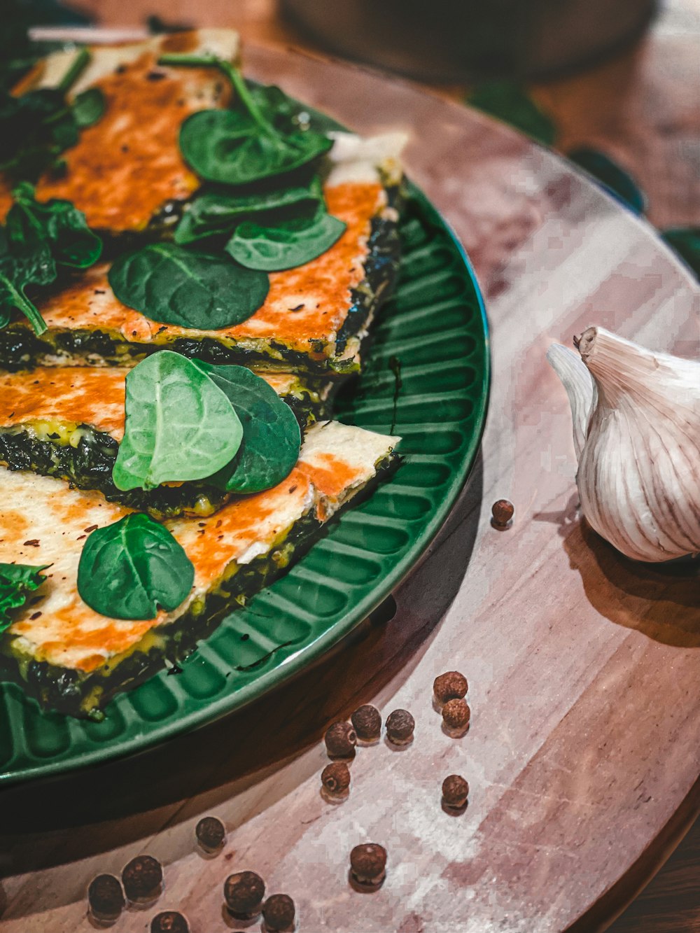 a pizza with leaves on it