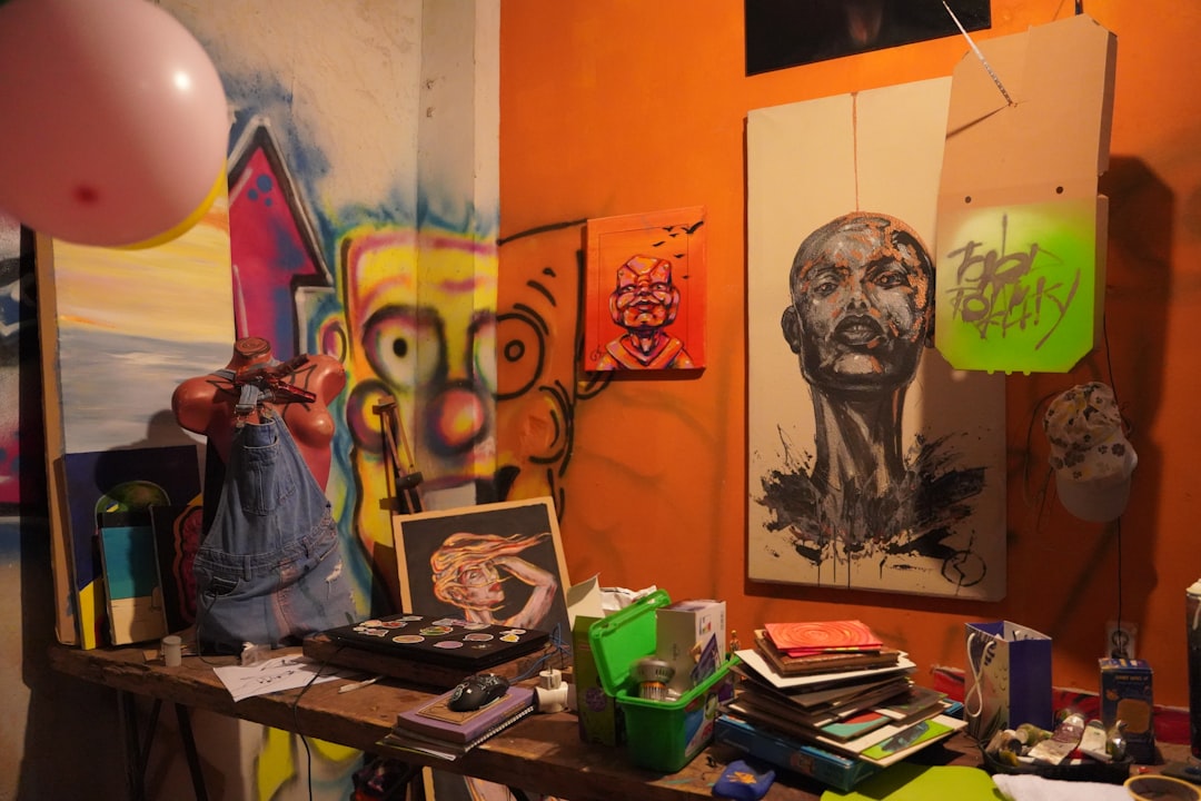 Design materials spread on table - laptop, fabric swatches, coffee cups, sketches