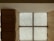 A modern interior with wooden walls and a large, backlit textured glass window panel divided into four sections by cross-shaped framework. The glass features intricate circular patterns, and the wood has a smooth, warm finish.