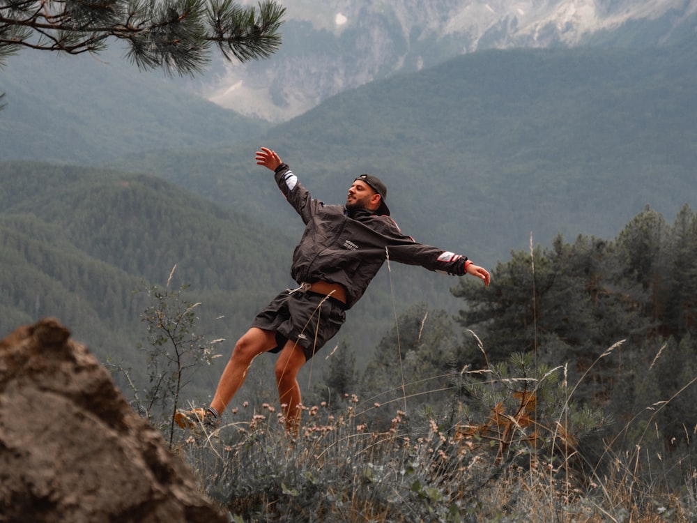 a man jumping off a cliff