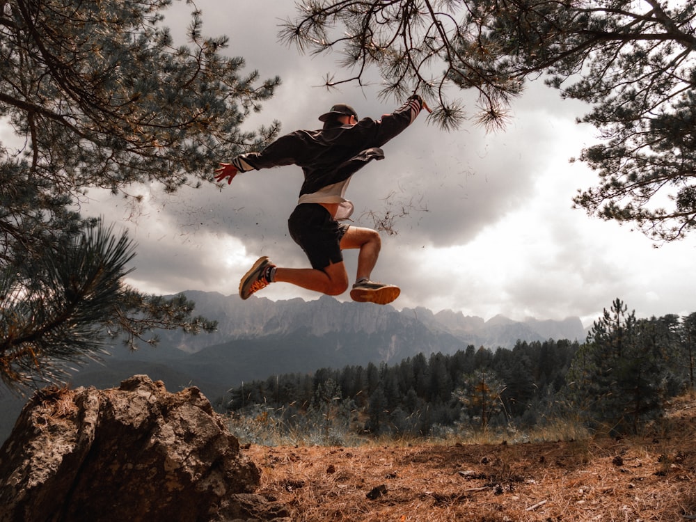 a man jumping off a rock