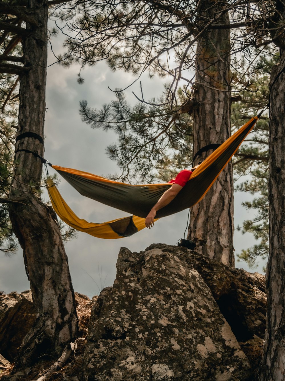 a person in a yellow tent from a tree