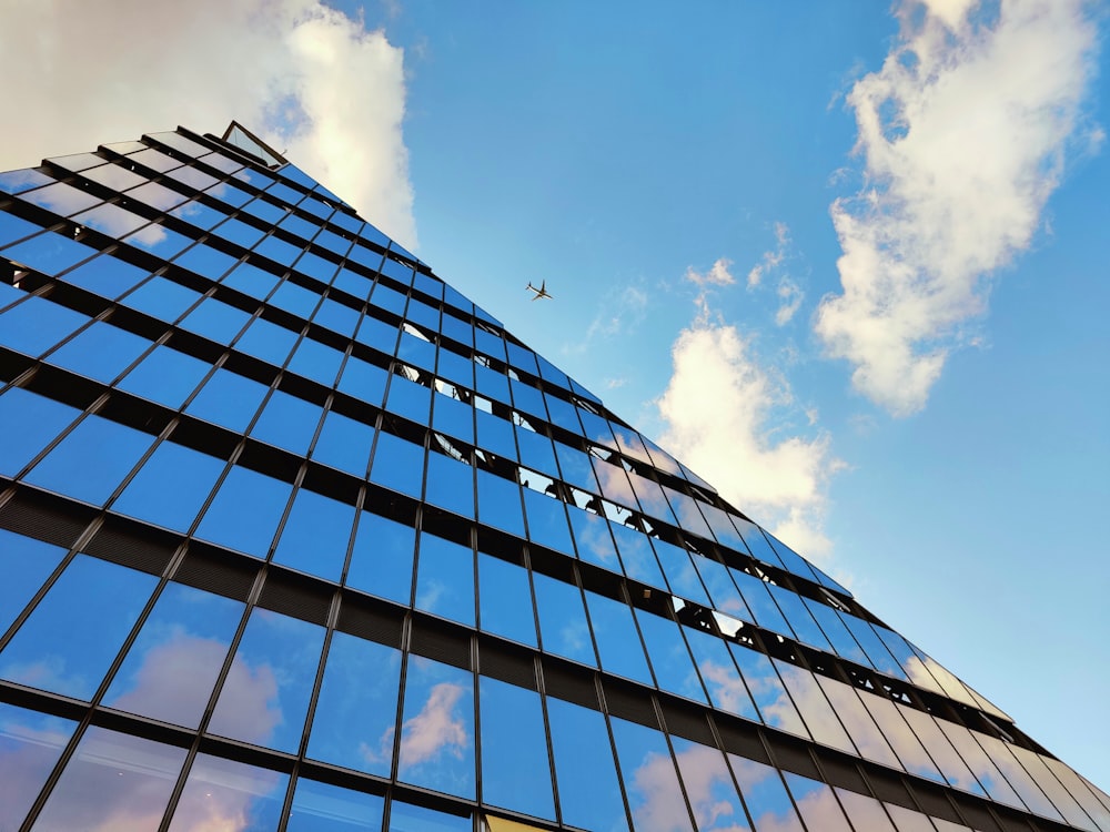 a plane flying over a tall metal tower