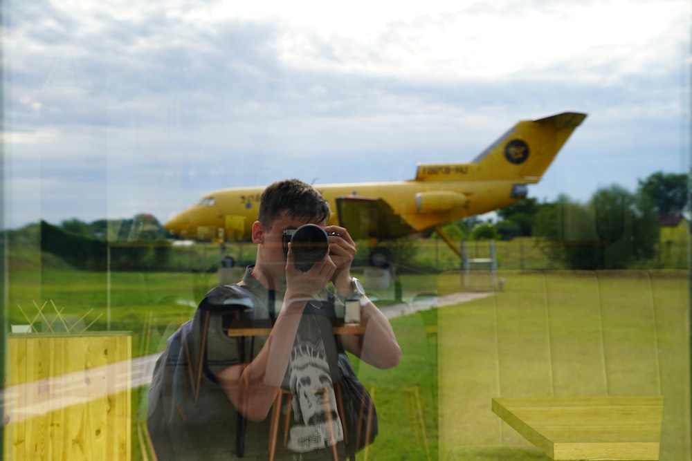 a man taking a picture of a plane