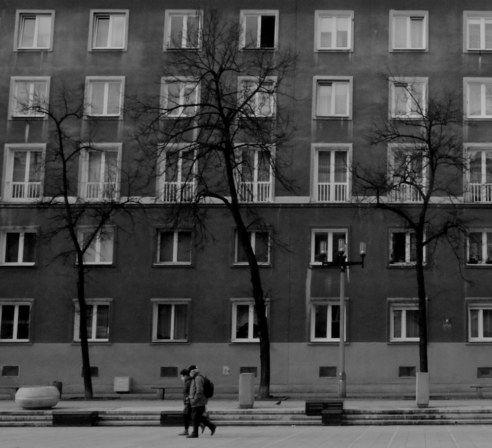 a couple of people standing in front of a building