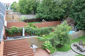 An aerial shot of a residential backyard transformed with layered planting and cozy seating areas