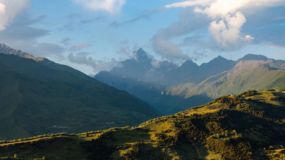 a valley with mountains in the background