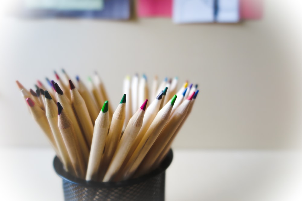 a group of pencils in a cup