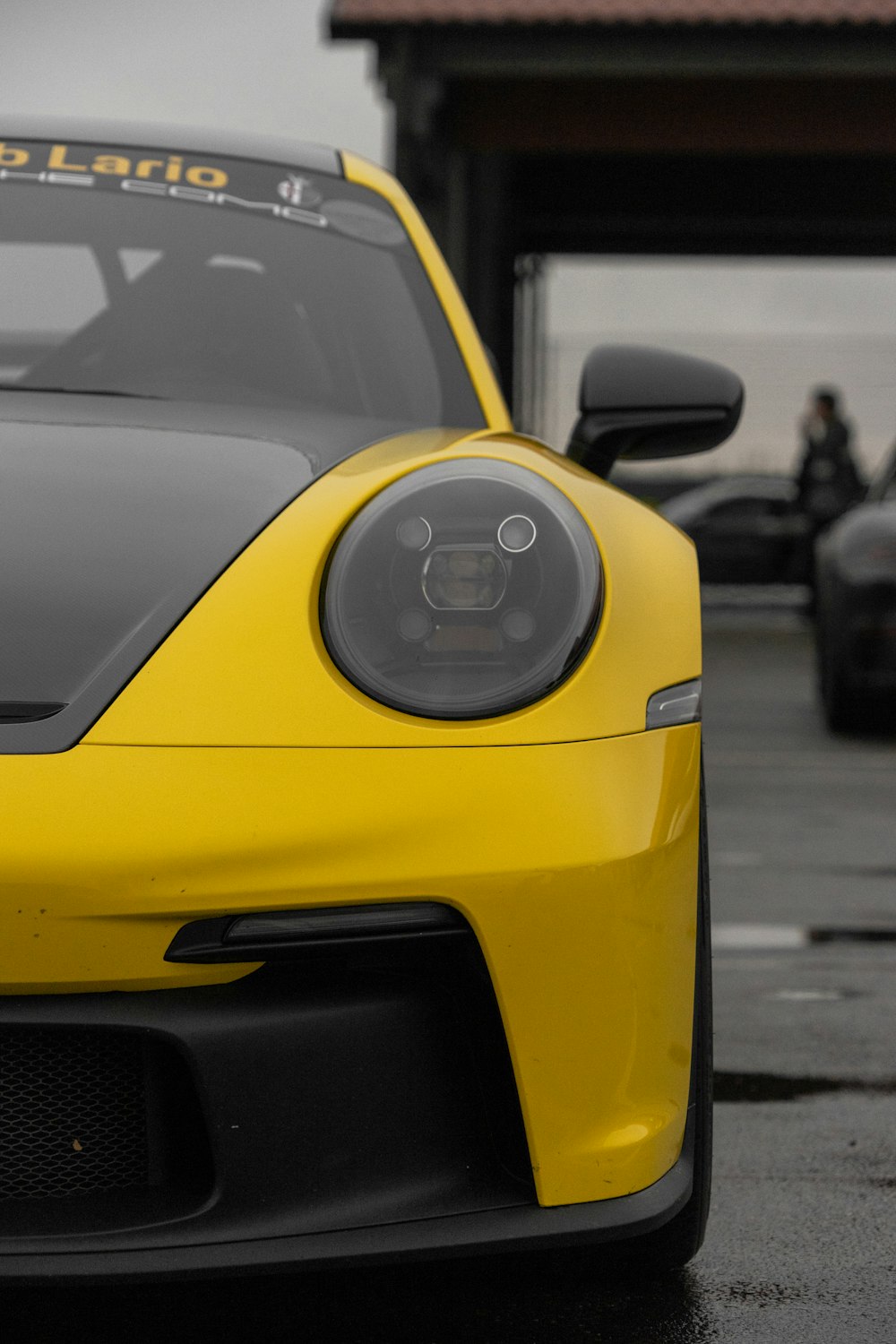 a yellow car with a black headlight