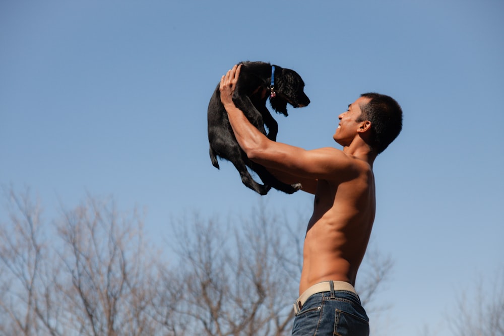 a man holding a dog