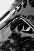 A close-up of a shiny car surface reflecting light.