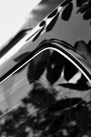 A close-up of a shiny car surface reflecting light.