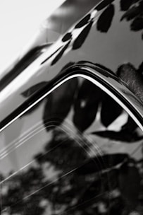 Close-up of a sparkling clean car surface reflecting the surroundings.