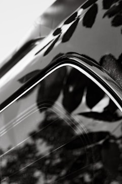 A close-up of a shiny car surface reflecting sunlight.