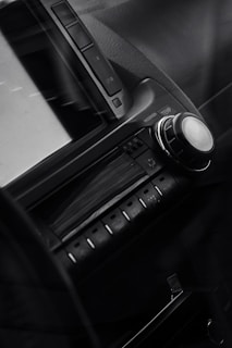 Close-up of a sleek car dashboard featuring a satellite radio receiver with clear signal display