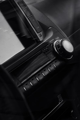 Close-up of a sleek car dashboard featuring a high-end stereo system with glowing controls.