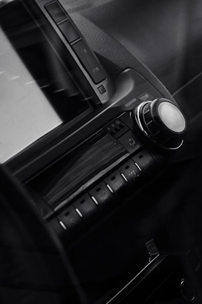 A sleek car dashboard displaying a modern radio interface with vibrant graphics and controls.