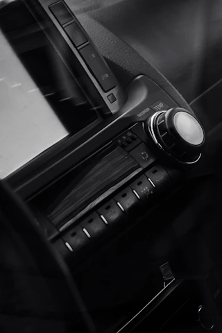 Close-up of hands installing a sleek car multimedia system.