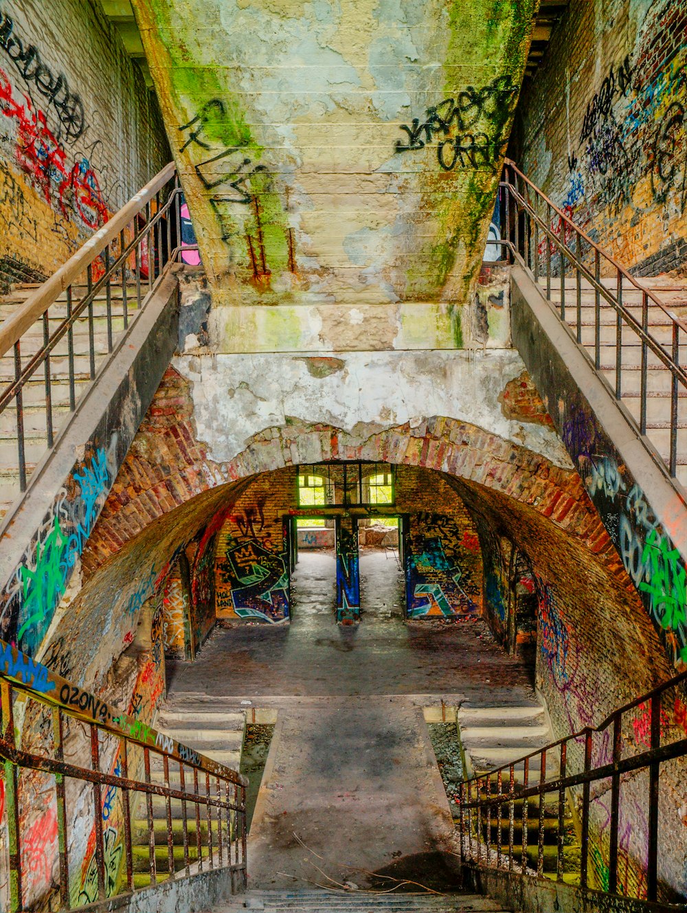 a narrow staircase with colorful walls