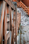 Close-up of a handcrafted walnut stair railing with visible wood grain.