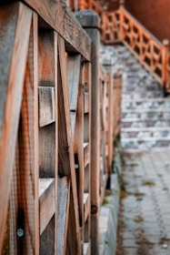 Close-up of a craftsman installing a custom wooden handrail on a staircase.