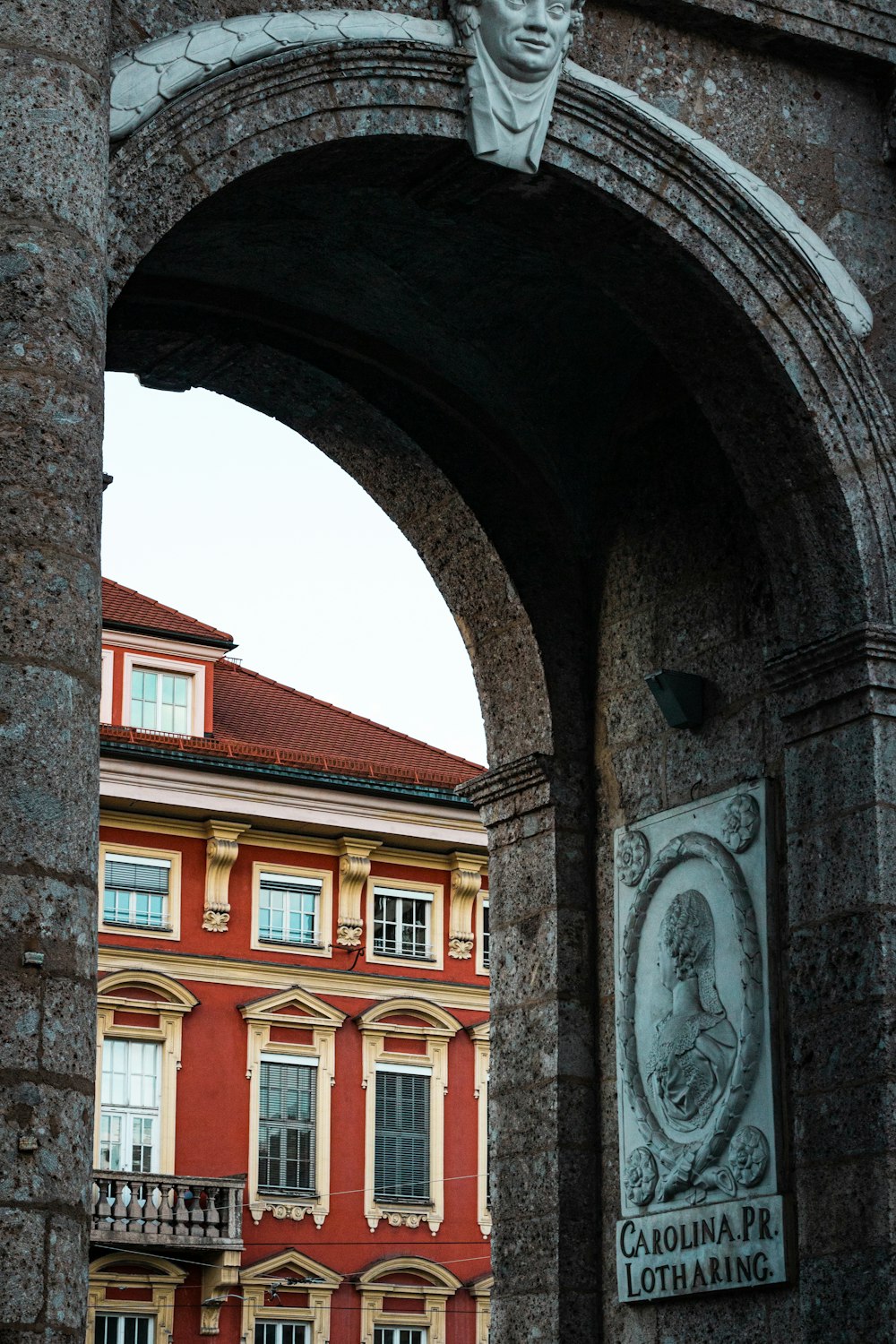 a stone archway with a statue on top