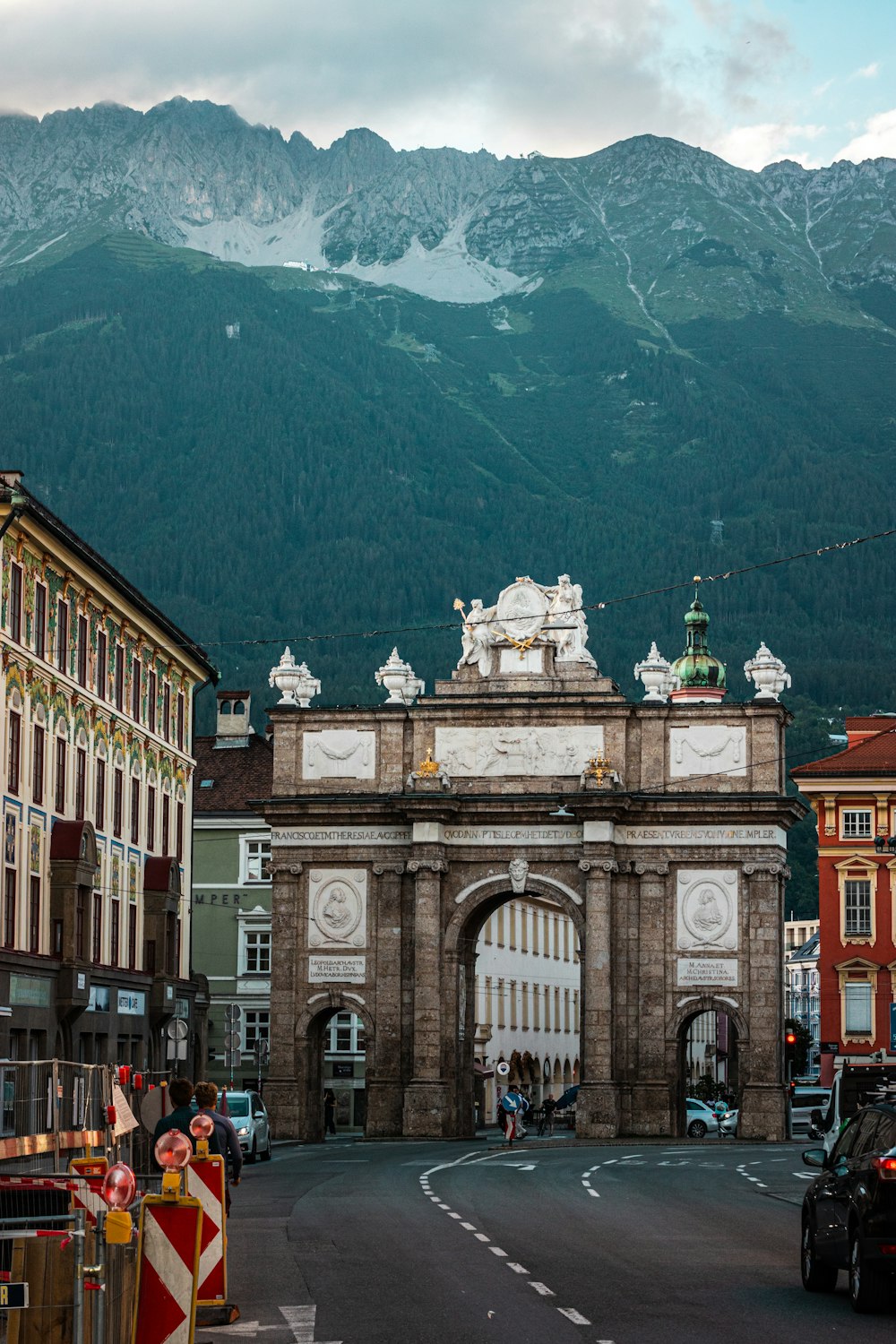 a large stone arch with a statue on top of it