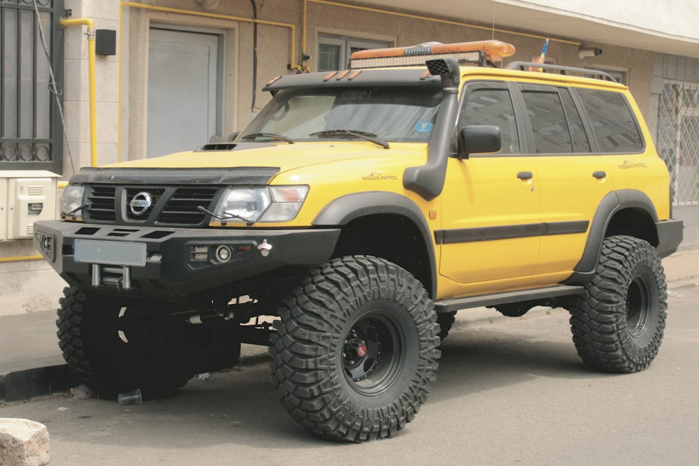 a yellow jeep parked in front of a building