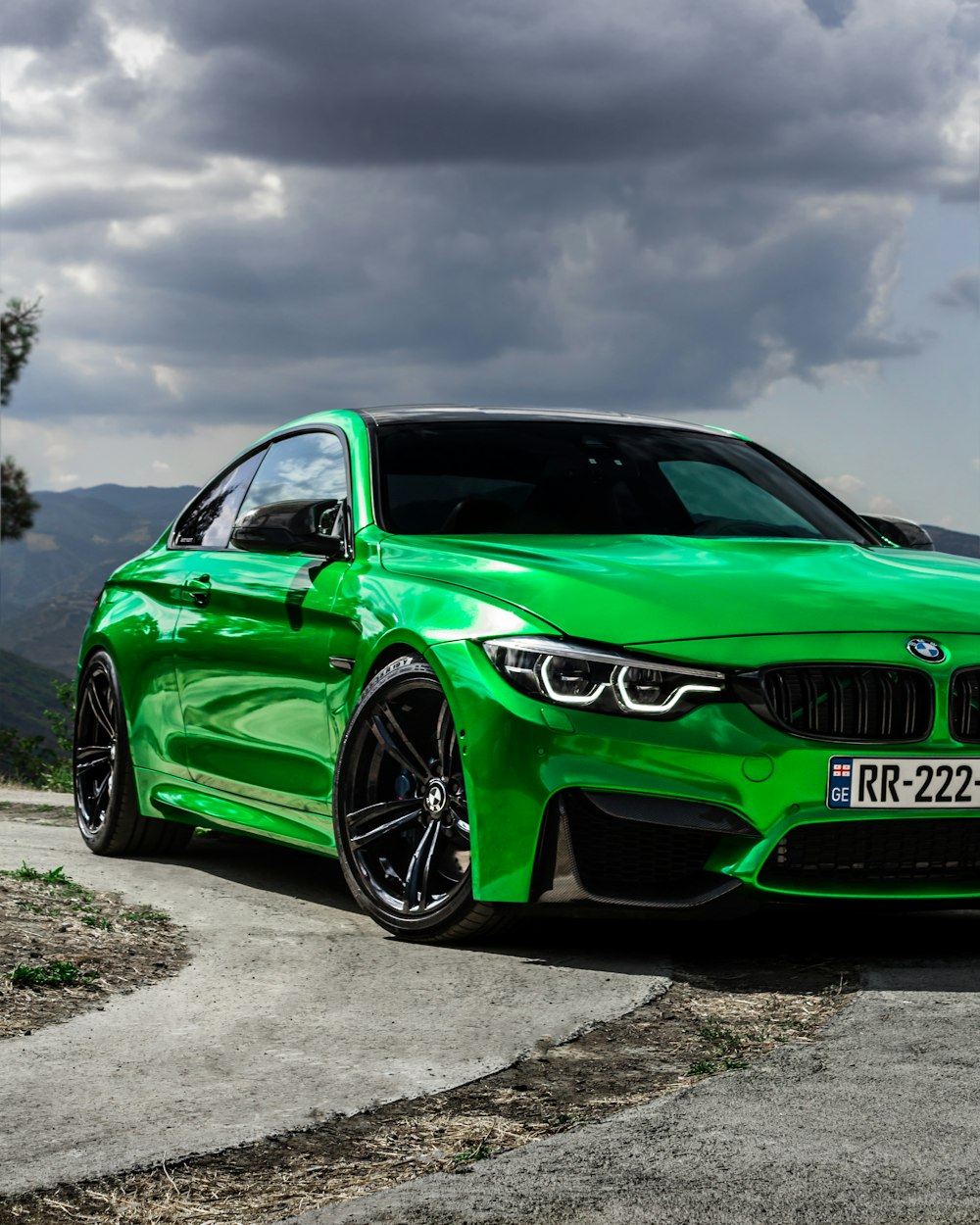 a green car parked on a road