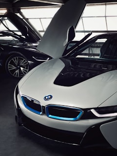 Electric blue accents glowing on a Tesla Model X with doors open in a luxury urban setting.