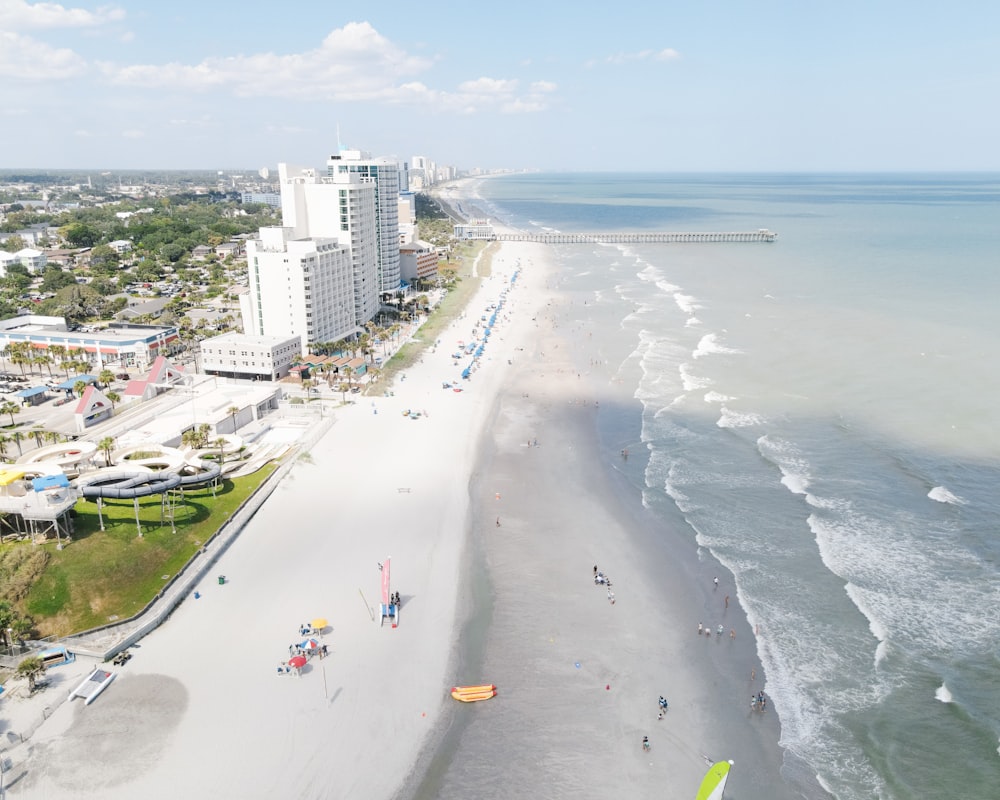 a beach with people on it and buildings by it