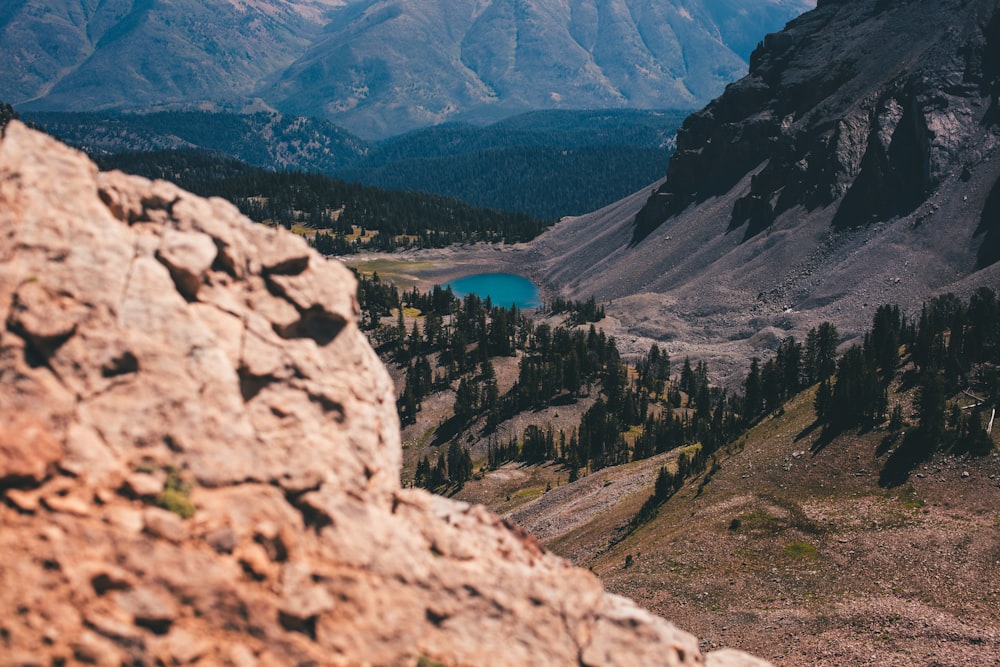 a rocky landscape with a lake in the distance