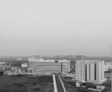 Drone view capturing a modern office building with clear access roads.