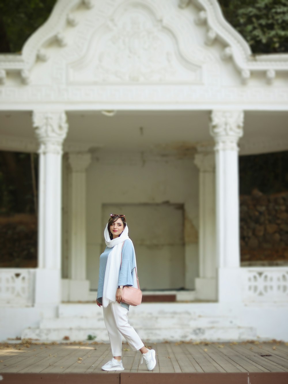 a person posing in front of a building