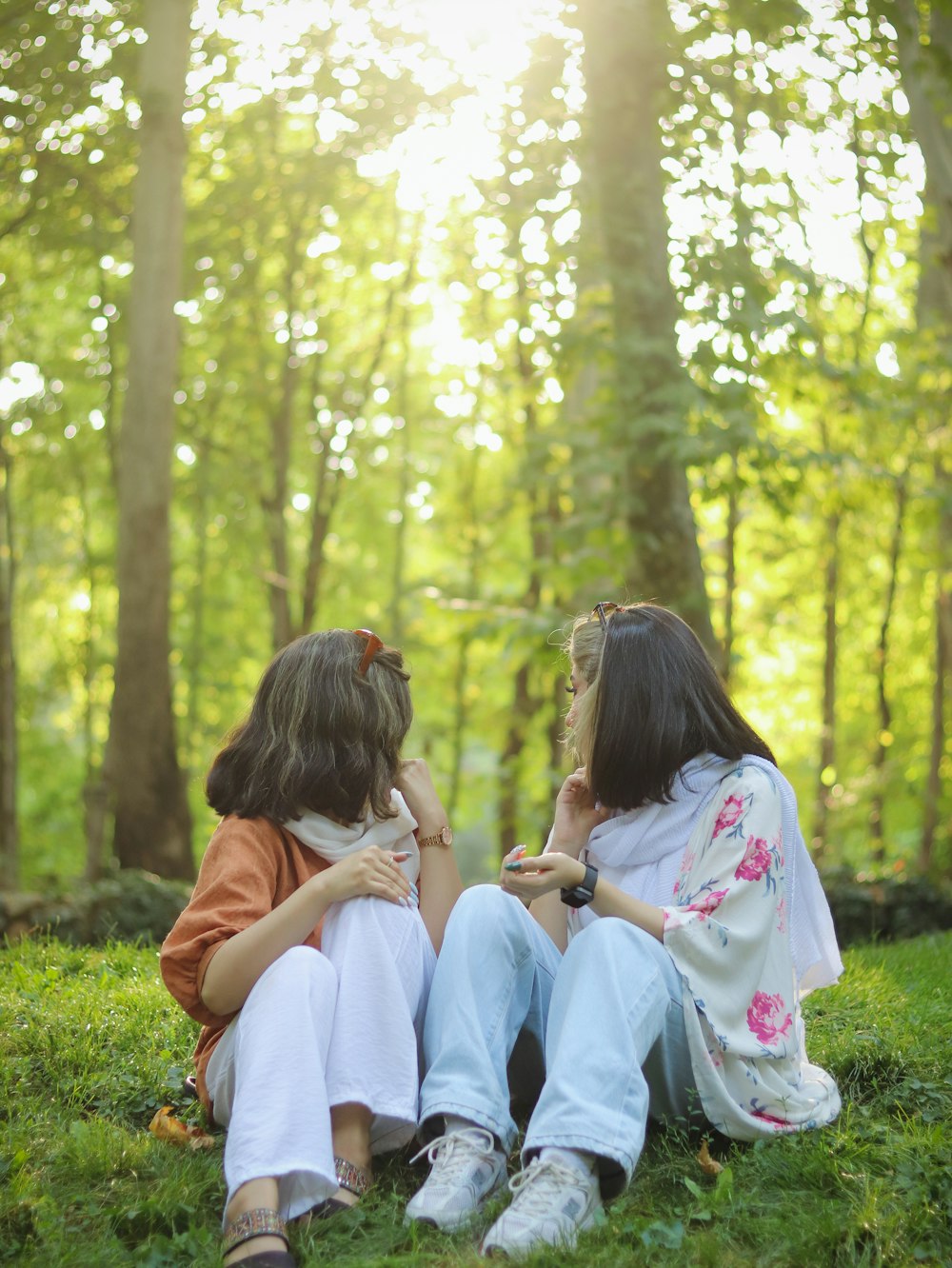 a group of girls sitting on grass