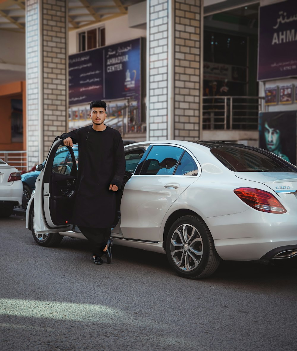 a person standing next to a car