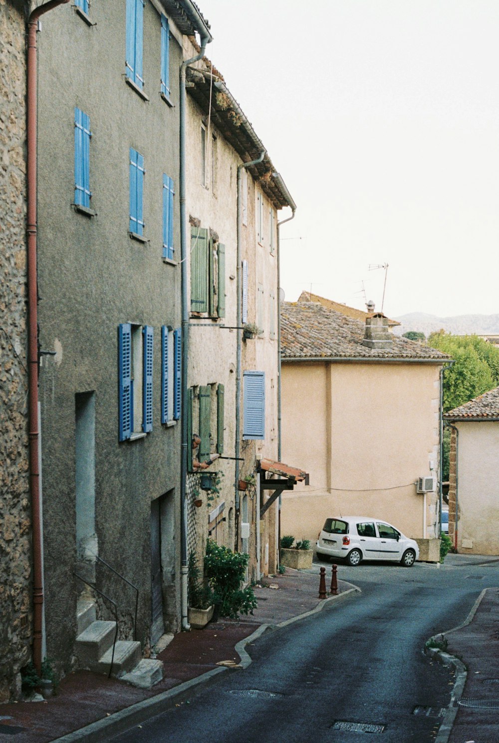 a white car parked on the side of a road