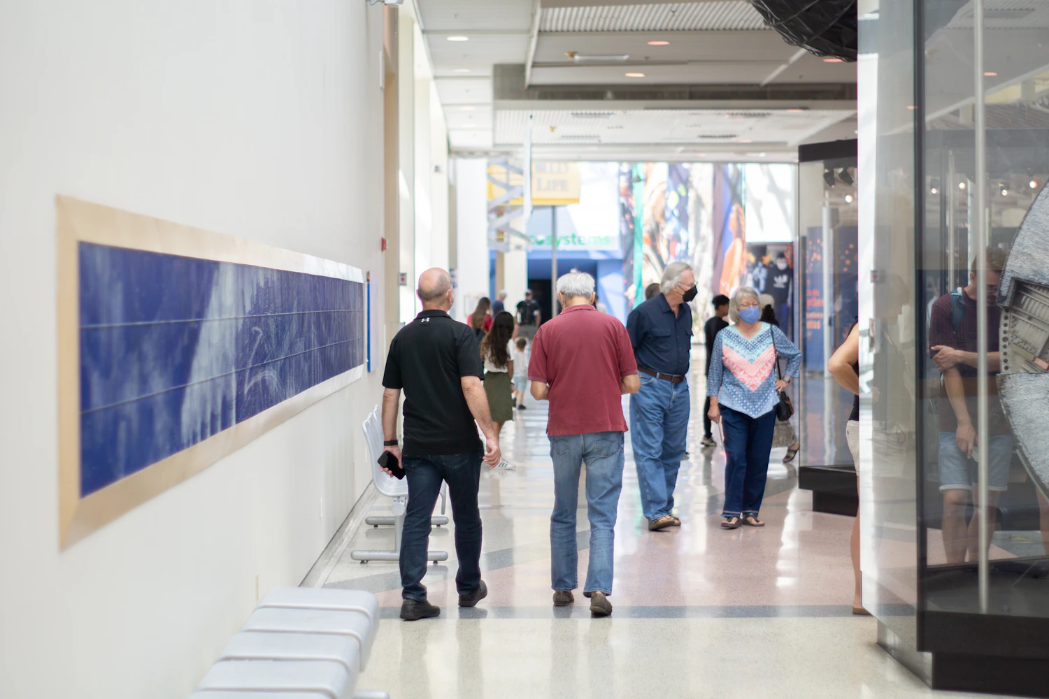 People gathered inside a large visual exhibition