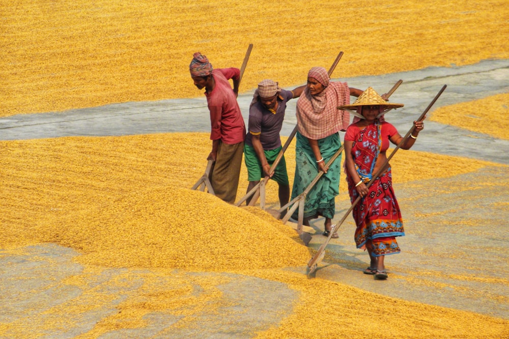 a group of people carrying brooms