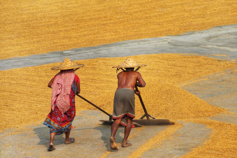 a couple of people carrying hats on their heads