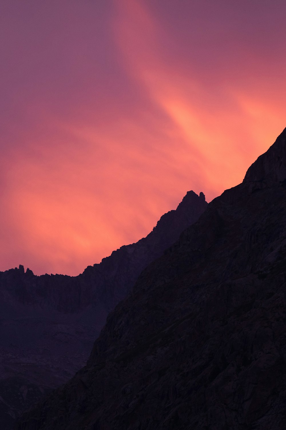 a mountain with a pink and purple sky