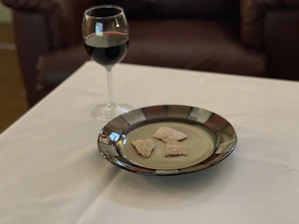 Cozy rustic table set with small plates of traditional Piedmontese snacks and a glass of red wine.