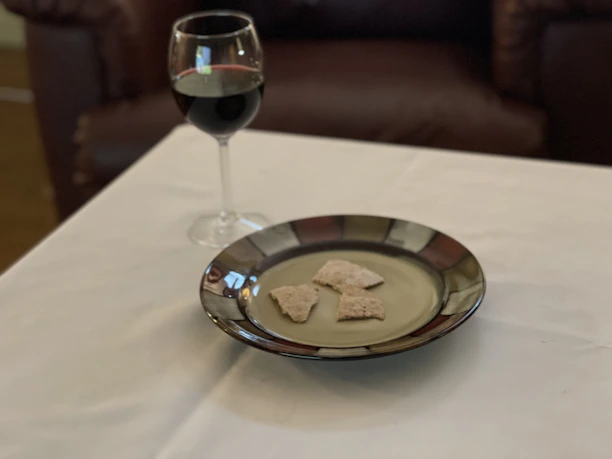 Cozy rustic table set with small plates of traditional Piedmontese snacks and a glass of red wine.