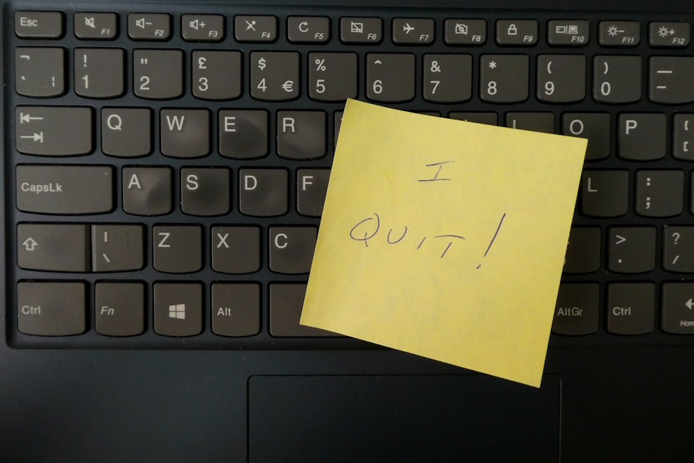 Yellow Post-It reading I quit on black keyboard