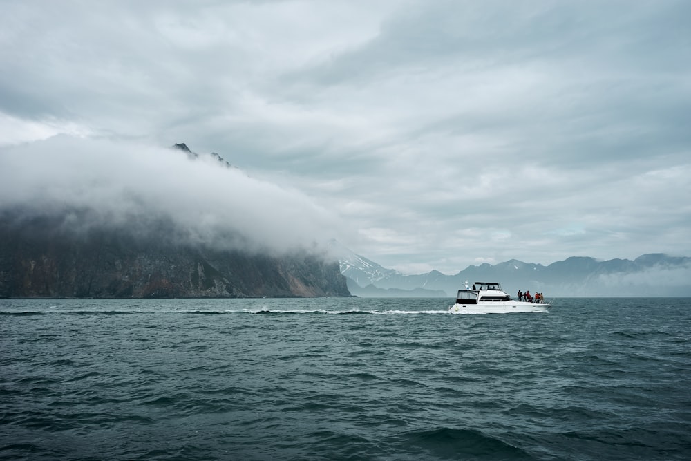 a boat in the water with a bird flying over it