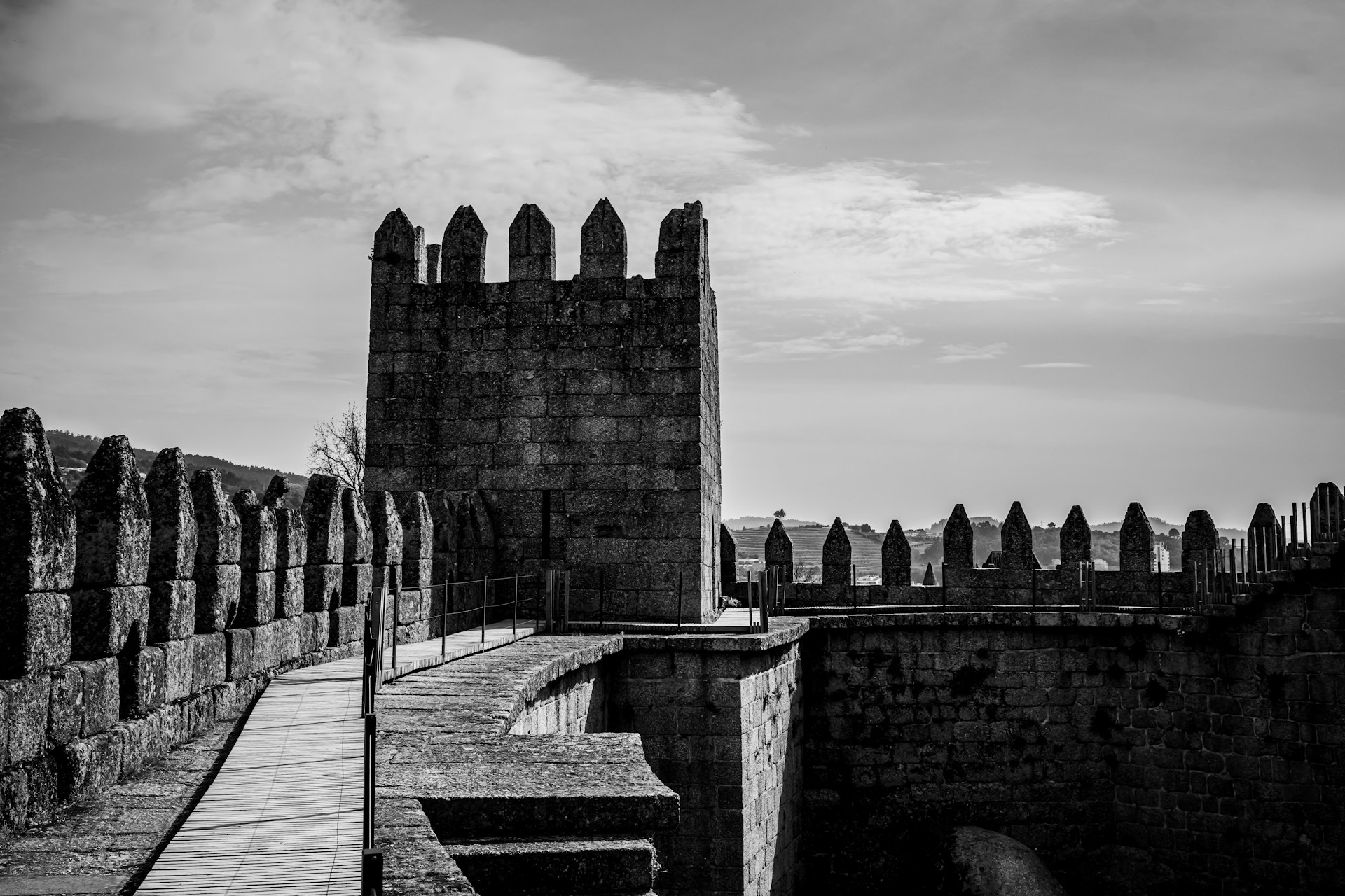 a stone wall with a stone walkway