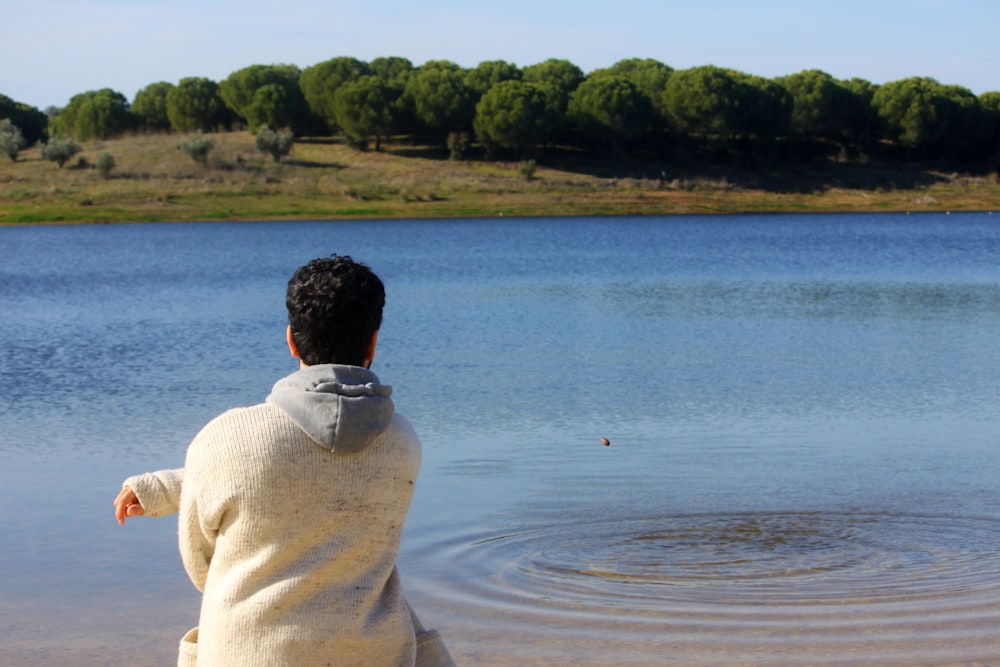 a man standing in front of a lake